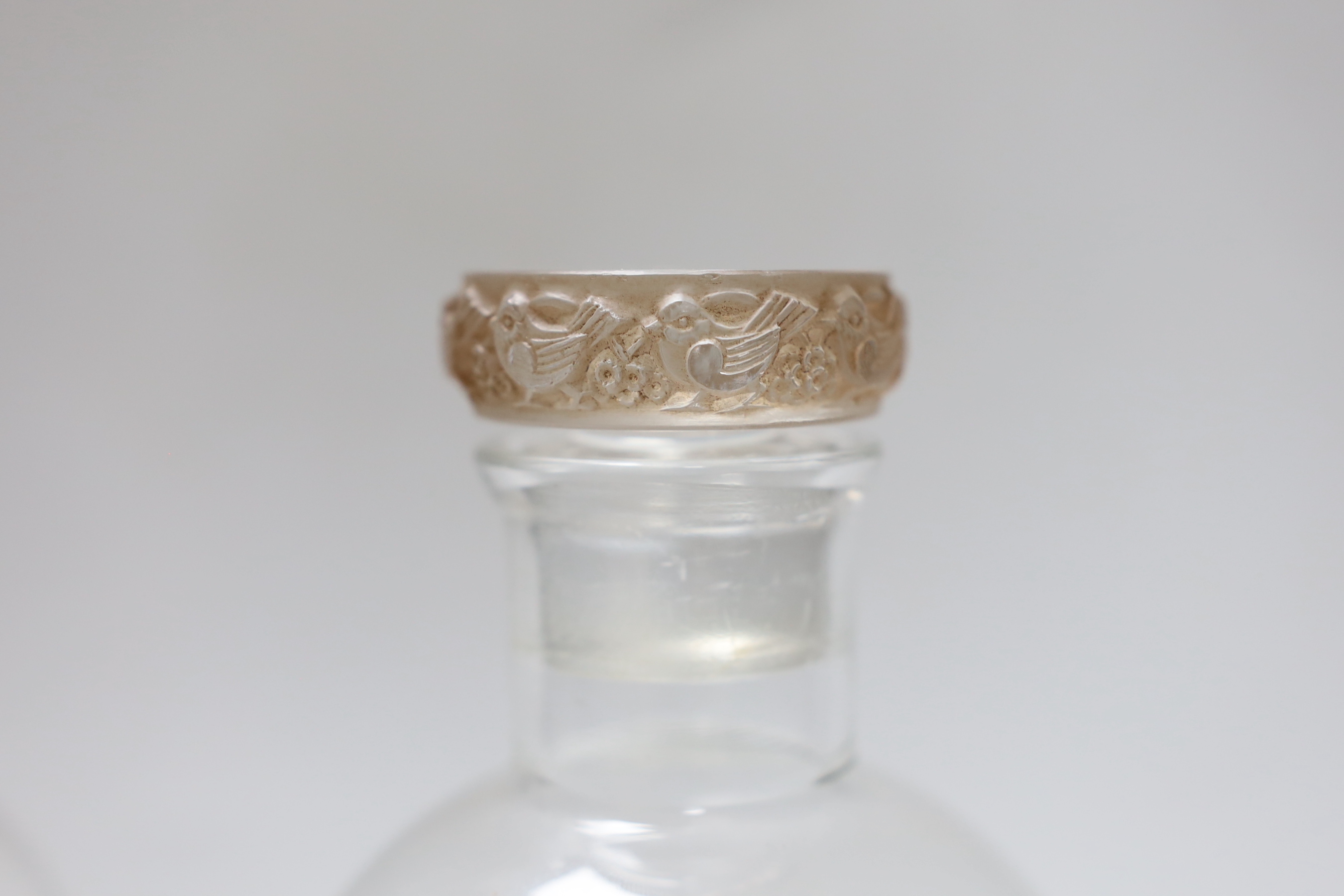 A near pair of Lalique glass decanters, one with blue tinted stopper, the other sepia tinted, 22cm tall